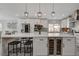 Stylish kitchen island with seating, wine cooler, stainless steel appliances, and modern pendant lighting at 5429 Painted Sunrise Ave, Las Vegas, NV 89149