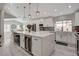 Modern kitchen featuring a large island with seating, stainless steel appliances, and a bright, open design at 5429 Painted Sunrise Dr, Las Vegas, NV 89149