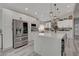Spacious kitchen with stainless steel appliances, a large island, modern lighting, and ample cabinet space at 5429 Painted Sunrise Dr, Las Vegas, NV 89149