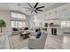 Bright living room with large windows, an open layout connecting the kitchen, and a comfortable seating area at 5429 Painted Sunrise Dr, Las Vegas, NV 89149