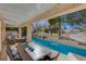 Inviting outdoor dining area under a pergola, next to a refreshing swimming pool and lush greenery at 5429 Painted Sunrise Dr, Las Vegas, NV 89149