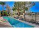 Backyard pool, surrounded by lush greenery, offering a serene retreat for relaxation and recreation at 5429 Painted Sunrise Dr, Las Vegas, NV 89149
