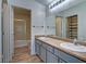 Bathroom with dual sinks, spacious vanity, and a glass-enclosed shower and large mirror at 5457 Jackpot Winner Ln # 101, Las Vegas, NV 89122