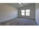 Bedroom features carpet, vaulted ceilings, and natural lighting from the two windows at 5457 Jackpot Winner Ln # 101, Las Vegas, NV 89122