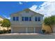 Two-story exterior elevation featuring a three-car garage and well-maintained landscaping at 5457 Jackpot Winner Ln # 101, Las Vegas, NV 89122
