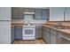Kitchen features stainless steel appliances, grey cabinets, laminate countertops and wood flooring at 5457 Jackpot Winner Ln # 101, Las Vegas, NV 89122