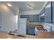 The kitchen features gray cabinets, a white refrigerator, and a gas range at 5457 Jackpot Winner Ln # 101, Las Vegas, NV 89122