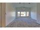 Living room showcasing vaulted ceilings, carpet and natural light from three windows at 5457 Jackpot Winner Ln # 101, Las Vegas, NV 89122