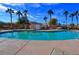 Community pool surrounded by palm trees, offering a refreshing and relaxing oasis at 5457 Jackpot Winner Ln # 101, Las Vegas, NV 89122