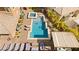 Aerial view of the backyard featuring a large swimming pool, spa, patio with lounging and dining areas at 5523 Kyle Peak Ct, Las Vegas, NV 89135