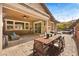 Cozy backyard patio with outdoor dining area, seating, and a barbecue grill at 5523 Kyle Peak Ct, Las Vegas, NV 89135