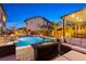 Backyard showcasing the outdoor pool, patio, and luxurious lounge area, perfect for entertaining at 5523 Kyle Peak Ct, Las Vegas, NV 89135