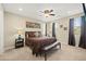 Comfortable bedroom featuring a ceiling fan, bench and lots of natural light at 5523 Kyle Peak Ct, Las Vegas, NV 89135