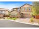 Spacious two-story home with a three-car garage, brick driveway, and landscaped front yard at 5523 Kyle Peak Ct, Las Vegas, NV 89135