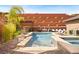 Stunning backyard featuring a pool with a spa, a built-in BBQ and a lounge area at 5523 Kyle Peak Ct, Las Vegas, NV 89135