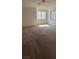 Spacious bedroom with neutral carpeting and plenty of natural light from large windows at 5564 Ness Ave, Las Vegas, NV 89118