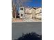 A two-story home with a two-car garage, desert landscaping, and a concrete driveway at 5564 Ness Ave, Las Vegas, NV 89118