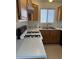 Traditional kitchen with a white countertops, oak cabinets, and a gas range cooktop at 5564 Ness Ave, Las Vegas, NV 89118