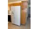 Bright kitchen featuring a large, white refrigerator and light wood cabinets at 5564 Ness Ave, Las Vegas, NV 89118