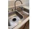 A close-up view of the kitchen's stainless steel double basin sink with a silver faucet at 5564 Ness Ave, Las Vegas, NV 89118