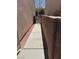 Narrow side yard featuring a walkway to the backyard at 5564 Ness Ave, Las Vegas, NV 89118