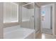 Bright bathroom featuring a tub and shower combo with glass doors, offering a clean and modern space at 5967 Grechetto Ct, Las Vegas, NV 89141