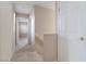 Bright hallway with carpeted stairs, white trim, and neutral walls offers a clean transition between levels at 5967 Grechetto Ct, Las Vegas, NV 89141