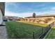 Spacious backyard showcasing a lush green lawn, bordered by a fence, offering privacy and room to enjoy the outdoors at 6130 Pebble Glen, Las Vegas, NV 89149