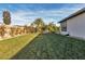 Large backyard featuring green grass and partial fencing, providing a private outdoor area for recreation and leisure at 6130 Pebble Glen, Las Vegas, NV 89149