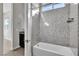 Modern bathroom featuring tub with shower and granite surround and vanity in view at 6130 Pebble Glen, Las Vegas, NV 89149