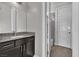 Modern bathroom with a granite countertop vanity and decorative tiled shower at 6130 Pebble Glen, Las Vegas, NV 89149