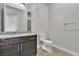 Bathroom with dark wood vanity, granite countertop, white toilet and tile flooring at 6130 Pebble Glen, Las Vegas, NV 89149