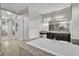 Luxurious bathroom featuring a soaking tub, walk-in shower, dual sinks and granite countertops at 6130 Pebble Glen, Las Vegas, NV 89149