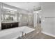 Bright bathroom featuring a soaking tub, walk-in shower, dual sinks and granite countertops at 6130 Pebble Glen, Las Vegas, NV 89149