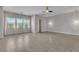 Open bedroom features tile flooring, a ceiling fan, and lots of natural light at 6130 Pebble Glen, Las Vegas, NV 89149