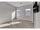 Bedroom with tile flooring, dual windows and wall-mounted television at 6130 Pebble Glen, Las Vegas, NV 89149