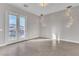 Large bedroom with tile flooring, modern hanging lights and access to an outdoor balcony at 6130 Pebble Glen, Las Vegas, NV 89149
