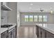 Open-concept kitchen with stainless steel appliances, dark cabinets, and plenty of natural light at 6130 Pebble Glen, Las Vegas, NV 89149