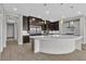 Gourmet kitchen featuring a large island, stainless steel appliances, and dark wood cabinets at 6130 Pebble Glen, Las Vegas, NV 89149