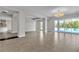 Large living room featuring tile floors, neutral walls, and access to the backyard pool at 6130 Pebble Glen, Las Vegas, NV 89149