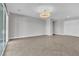 Bright open living room features tile floors, neutral walls, and modern lighting fixture at 6130 Pebble Glen, Las Vegas, NV 89149