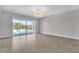 Open living room features tile floors, neutral walls, and access to the backyard pool at 6130 Pebble Glen, Las Vegas, NV 89149