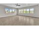 Bright living room with tile floors, a ceiling fan, and lots of windows at 6130 Pebble Glen, Las Vegas, NV 89149