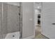 Modern shower with glass doors and textured stone-look shower walls at 6130 Pebble Glen, Las Vegas, NV 89149