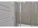 Shower with a tiled shower wall and glass doors at 6130 Pebble Glen, Las Vegas, NV 89149