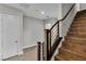 Staircase features modern railings with contrasting wooden treads and a white door at 6130 Pebble Glen, Las Vegas, NV 89149