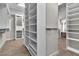 Large walk-in closet featuring white cabinets and closet organizer at 6130 Pebble Glen, Las Vegas, NV 89149