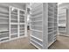 Spacious walk-in closet featuring white cabinets and closet organizer at 6130 Pebble Glen, Las Vegas, NV 89149