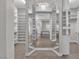 Bright walk-in closet featuring mirror decorations, white cabinets and closet organizer at 6130 Pebble Glen, Las Vegas, NV 89149