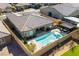 Aerial view of a private backyard oasis with a sparkling swimming pool and outdoor kitchen at 6192 Lautman Ridge Ct, Las Vegas, NV 89141